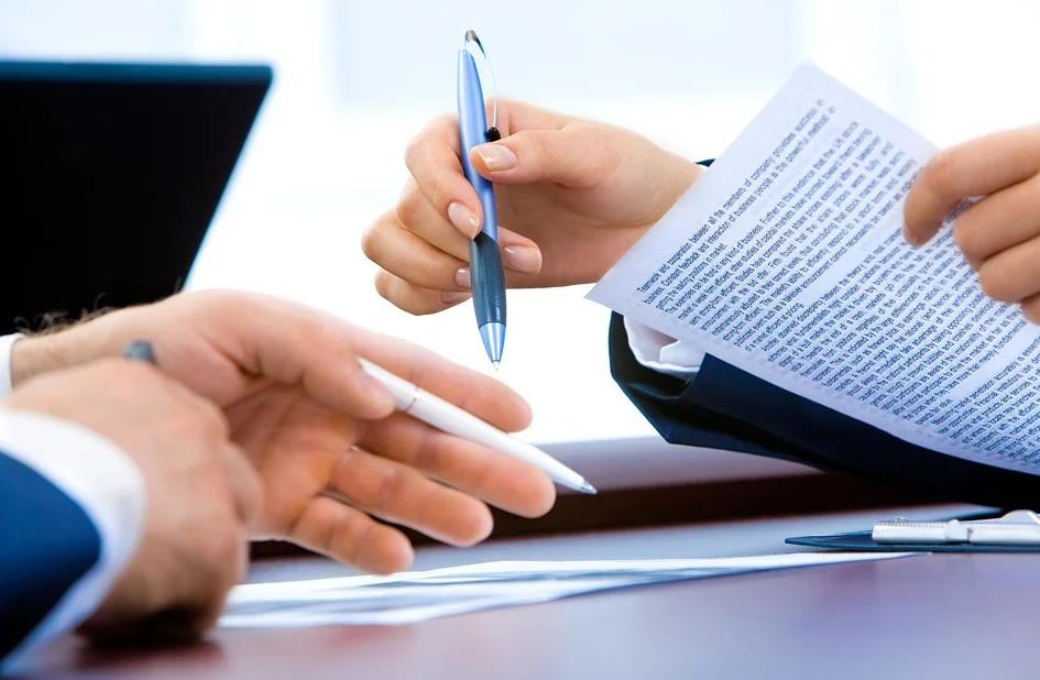 holding a pen and paper